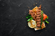 Lamb Kebab. Pita bread and spices. On a black background. Top view.