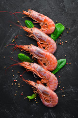 Large shrimp with lemon. Top view. Free space for your text. On the old background.