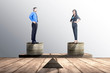 Asian businessman and businesswoman standing on coins stack with same height on balancer