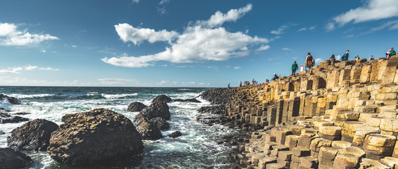 Wall Mural - tourists on the boulders beach. northern ireland. picturesque panoramic view. uncommon irish shore o