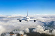 Airplane flying in the clouds. Front view aircraft.