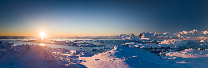 Wall Mural - sunset panoramic view of snow covered antarctic land. picturesque south pole scenery. beauty of the 