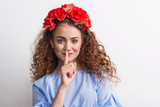 Fototapeta Łazienka - A front view of young beautiful woman with red flower headband.