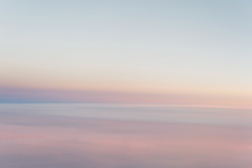 Wall Mural - sky in the pink and blue colors from aiplane window. effect of pastel colored of sunset clouds