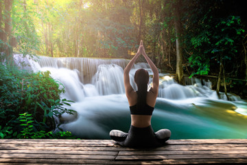 Young woman practicing yoga in the nature.female happiness. Landscape background