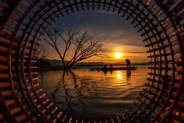 Beautiful landscape of fisherman on the wooden boat during the morning..