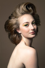 Portrait Of A Young Woman With Make Up Wearing Her Hair In A Big Hair Style, Profile.