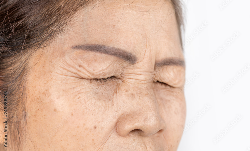close up skin wrinkle and freckles of old asian woman face which closing eyes - obrazy, fototapety, plakaty 