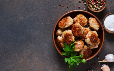 Wall Mural - Meat balls with spices on a concrete background. View from above.