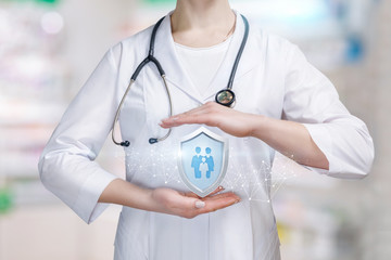 Wall Mural - A family medicine doctor with protection shield between her palms.