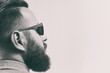 Black and white portrait of a bearded man with a stylish haircut.