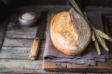 Freshly baked homemade traditional bread on rustic wooden table