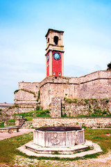 Wall Mural - beautiful landscape with a clock and bell tower in the old fortress in kerkira, corfu, greece. popul