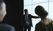 © JonoErasmus - Indian businessman pointing at digital screen during a presentation
