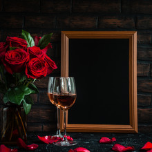 Bouquet Of Red Roses In Glass Vase With Black Board Mock Up Frame For Text In Background Against Brick Wall, Passion Love Valentine Greeting Card With Heart Shape Petals, Romantic Dating, Copy Space