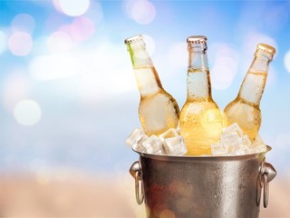 Bottles of cold and fresh beer with ice isolated