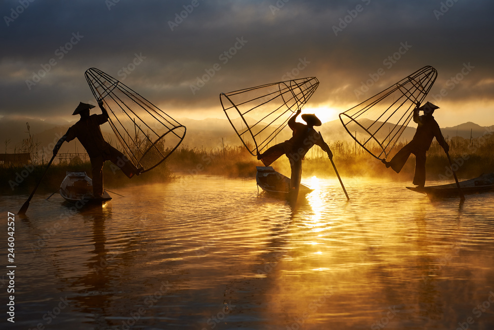 Silhouettes of three fishermen on Inle lake Myanmar - obrazy, fototapety, plakaty 