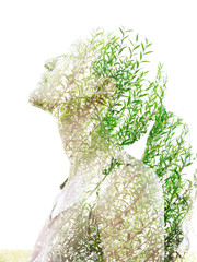 double exposure effect of a young woman's profile combined with perfectly captured tropical leaves