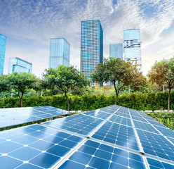 Wall Mural - ecological energy renewable solar panel plant with urban landscape landmarks