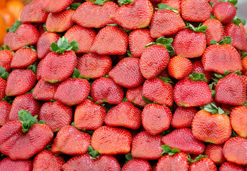 Red fresh and juicy strawberries in the market