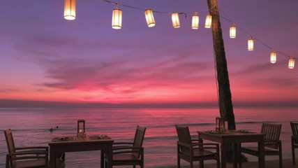 Wall Mural - Romantic sunset on the beach on tropical island, Koh Chang, Thailand. Outdoor cafe on the beach.