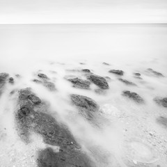 Wall Mural - Black White Long exposure artistic landscape, sea stones