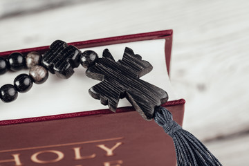 Sticker - Bible and a crucifix on an old wooden table. Religion concept.