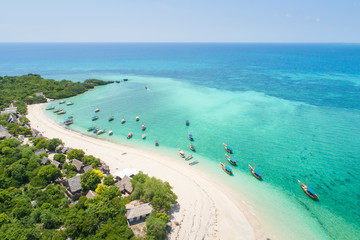 curved coast and beautiful beach with boats on zanzibar island