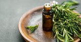 Fototapeta Storczyk - Rosemary essential oil with rosemary herb bunch