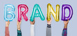 © Rawpixel.com - Hands showing brand balloons word