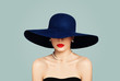 © millaf - Elegant woman fashion model with red lips makeup wearing classic hat and white pearls, portrait