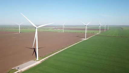 Wall Mural - Aerial view at wind power station on field. Technology and inovation. Green energy composition. Wind turbines. Industrial landscape