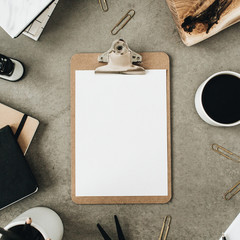 Wall Mural - Flat lay of clipboard with copy space blank mock up. Top view home office desk workspace decorated with wooden board, coffee, notebook and stationery. Social media / blog / website mockup concept.