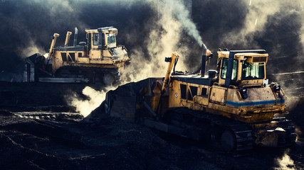 Two excavators are working, coal mining, sunlight