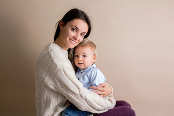 Sticker - Happy young mother with a toddler child on light beige background