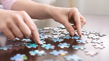 Elderly Woman Hands Doing Jigsaw Puzzle Closeup