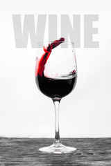 Red wine in the glass splashes in motion on a white background. Stylish design card with text