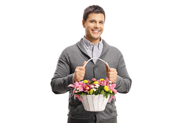 Poster - Happy young man holding flowers in a basket