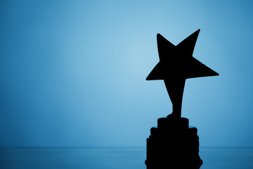 Wall Mural - star trophy silhouette, blue background
