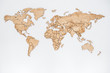 Wooden world map on a white wall. Geography concept. Background for travel. Logistics and transportation, worldwide business. All continent. Europe, America, Australia and Asia.