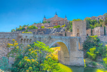 Alcantara Bridge Over River Tajo With Alcazar Castle At Background At Toledo, Spain