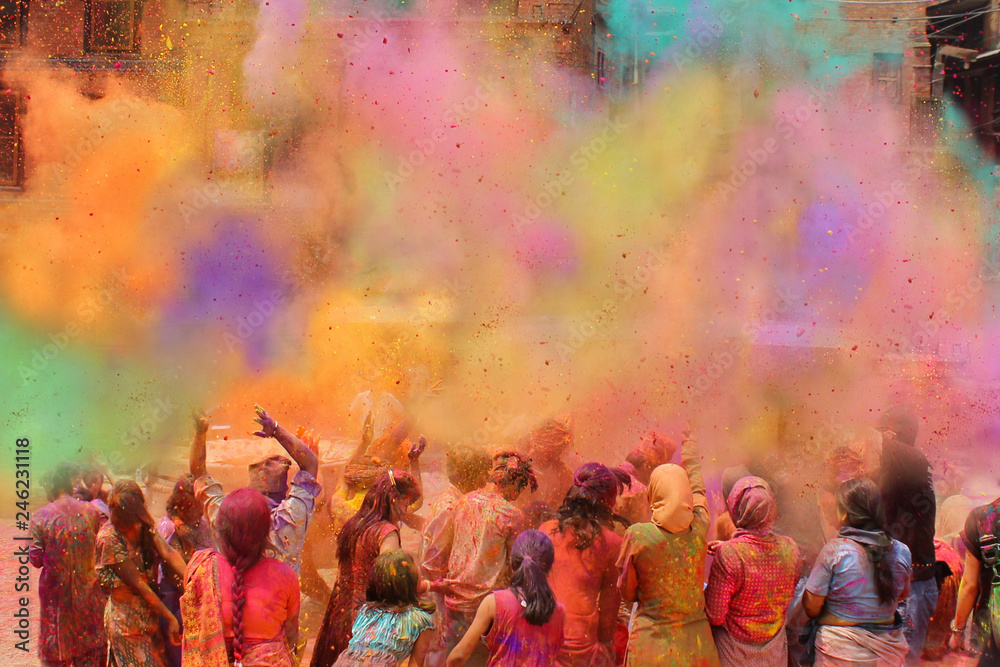 People celebrating Holi festival of colors, India  - obrazy, fototapety, plakaty 