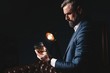 © opolja - Degustation, tasting. Man with beard holds glass of brandy. Tasting and degustation concept. Bearded businessman in elegant suit with glass of whiskey