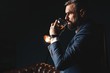 Degustation, tasting. Man with beard holds glass of brandy. Tasting and degustation concept. Bearded businessman in elegant suit with glass of whiskey