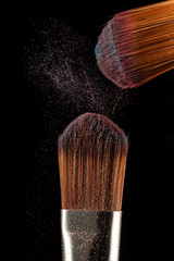 Sticker - Close up powder splash and brush for makeup artist or beauty blogger in black background