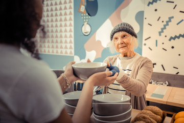 Wall Mural - Pleasant hungry woman taking a bowl with soup