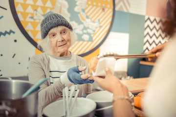 Wall Mural - Poor hungry woman looking at the food