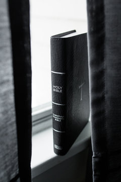 Black Holy Bible on Windowsill