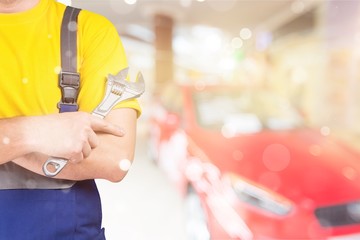 Sticker - Worker holding wrench in hand on background,close up