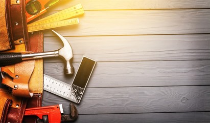 Wall Mural - Tool belt with tools on wooden background